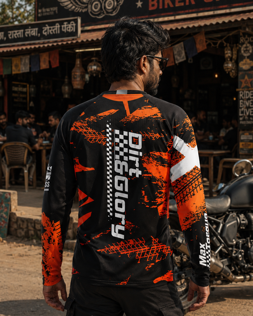 Person wearing a black and orange 'Dirt Biking' jersey in front of a biker cafe.