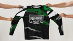 Green and black long-sleeve shirt with 'Pavement Pilot' logo held by four hands on a white background