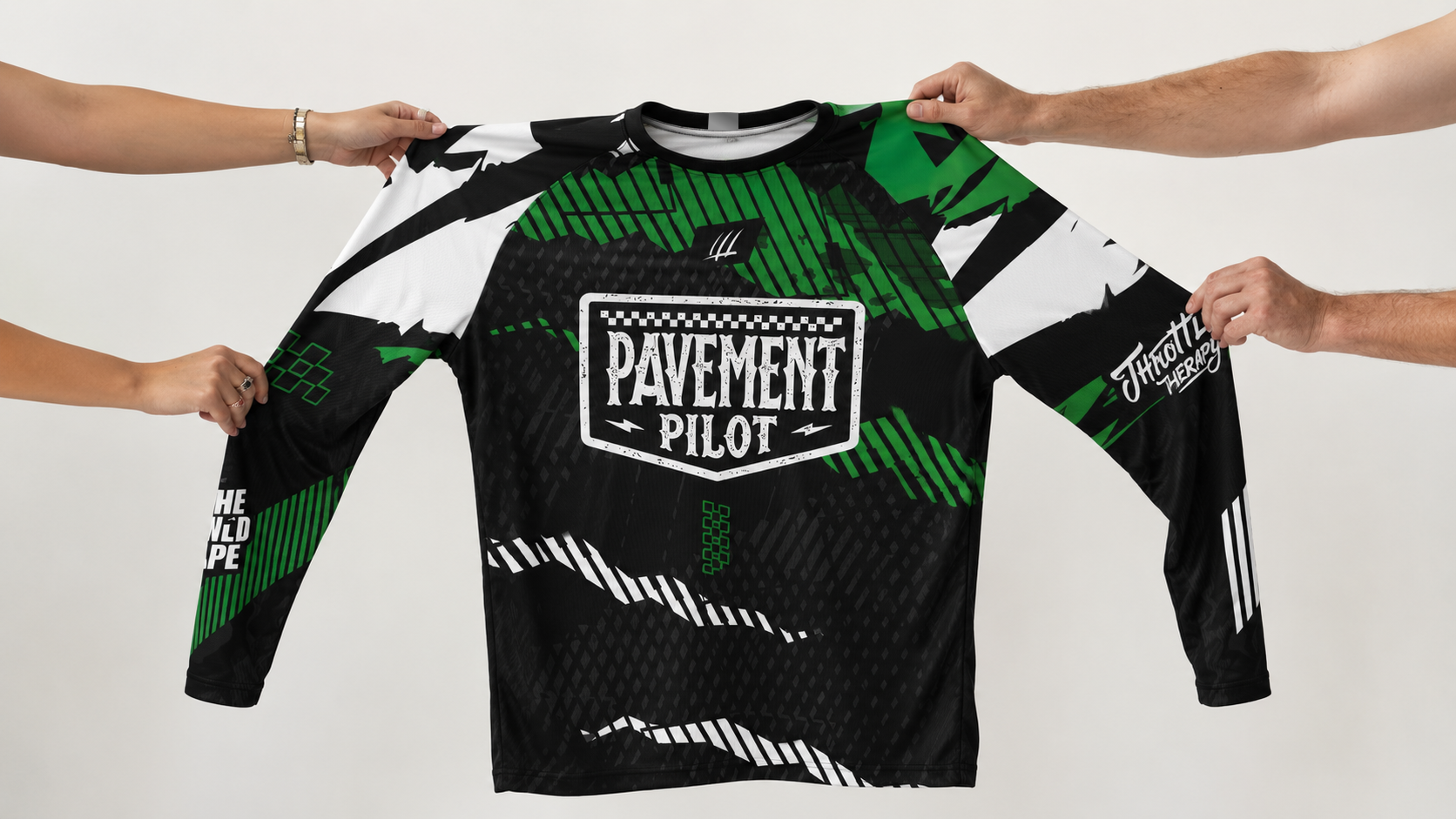 Green and black long-sleeve shirt with 'Pavement Pilot' logo held by four hands on a white background