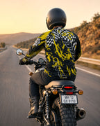 Person riding a motorcycle on a road with a scenic background