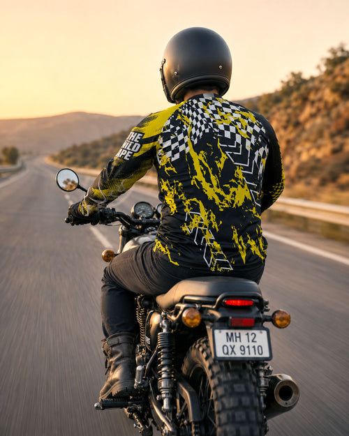 Person riding a motorcycle on a road with a scenic background
